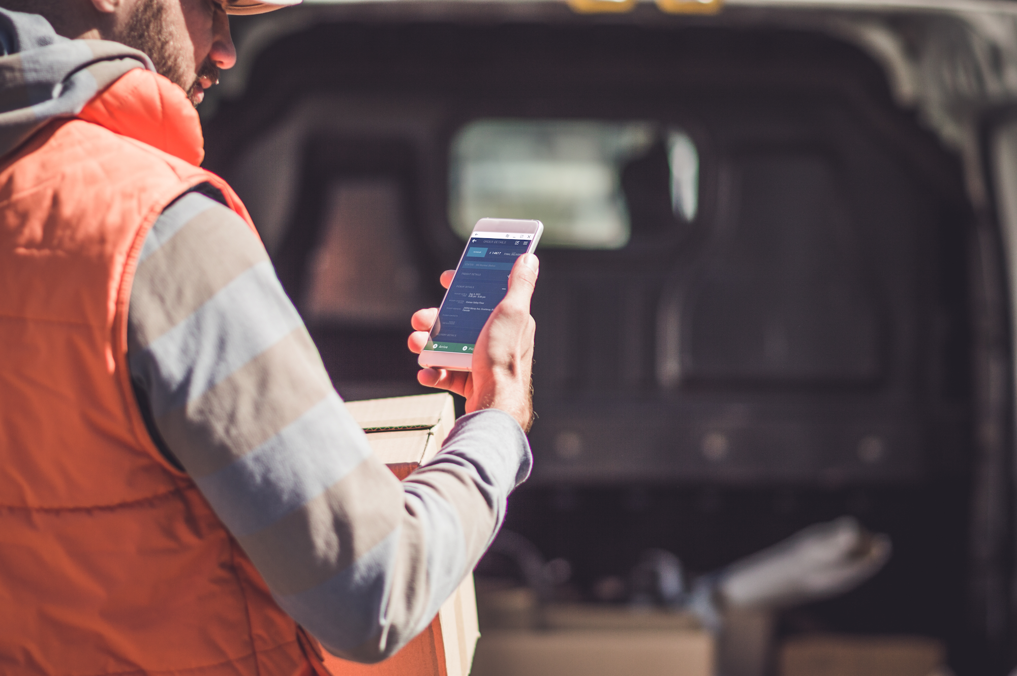 Trucker using DTMS Trucking sofware on mobile phone