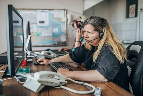 Trucking dispatchers working on computer screen